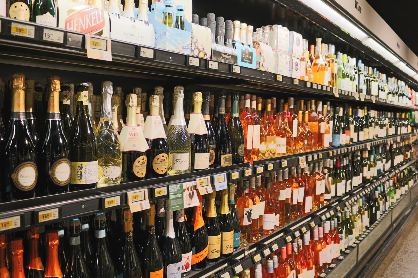 Looking along a run of open wine cabinets with a blade on every shelf edge