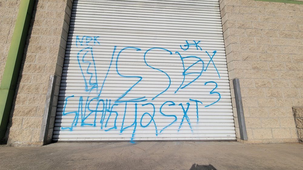 Blue tags across a white loading dock roller door, with blockwork either side