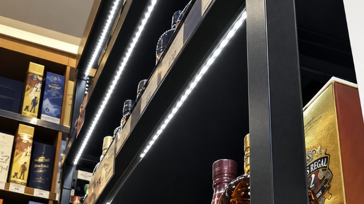 LED strip lighting fitted along retail shelving