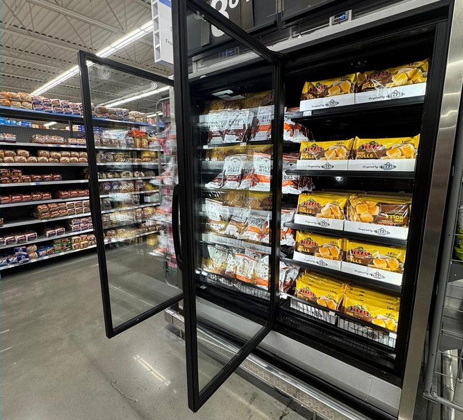 A freezer door with Clarifoil Anti-Fog Film fitted, the glass clear and the packaged bread rolls on the shelves behind it plainly visible