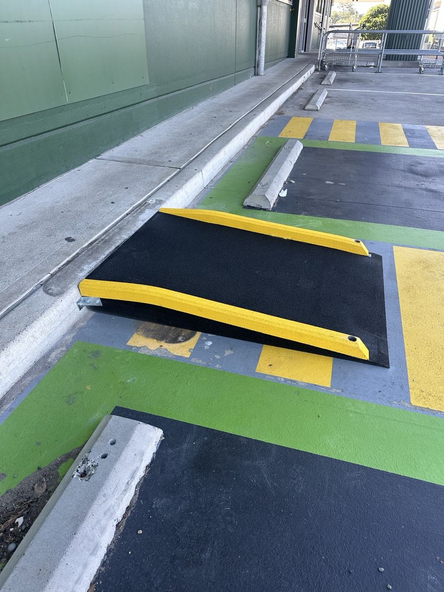 The replacement kerb ramp, bolted to the kerb