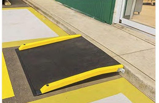 A kerb ramp up to the footpath beside a store entrance