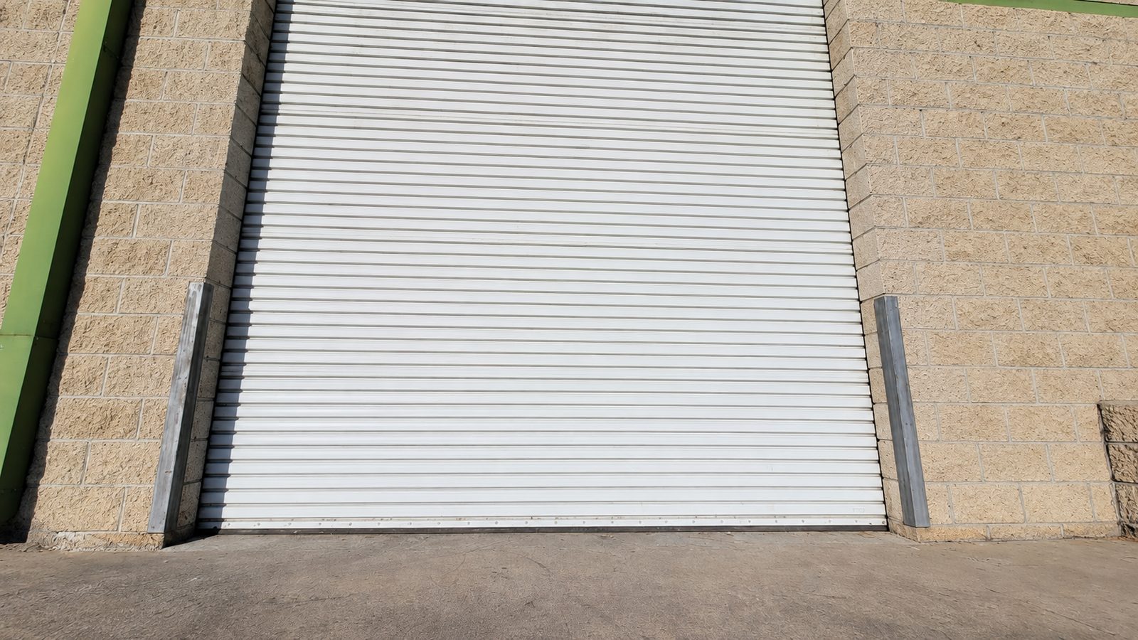 A back of house roller door with graffiti removed and repainted