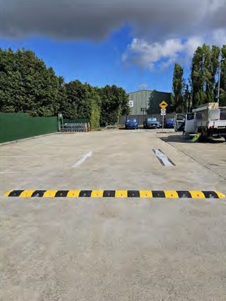 A speed hump across an open car park aisle