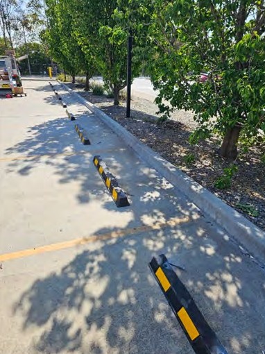 A line of wheel stops along a landscaped kerb